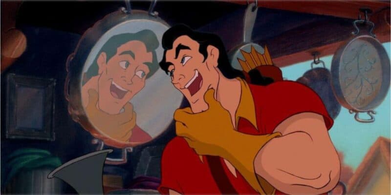 Gaston strokes his chin and stares at his reflection in the mirror