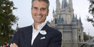 Josh D'Amaro in front of Cinderella Castle