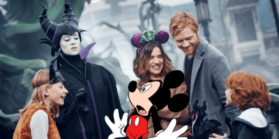 Maleficent interacting with Guests at Disneyland Paris with Mickey Mouse surprised in the foreground
