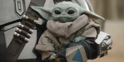 Grogu being held by Din Djarin (Pedro Pascal) in 'The Mandalorian'