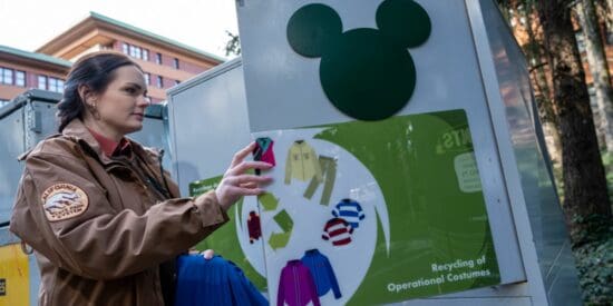A female Cast Member puts her costume in the recycling bin