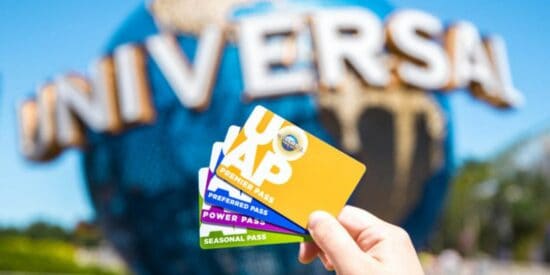 A woman's hand holding Universal Annual Passes