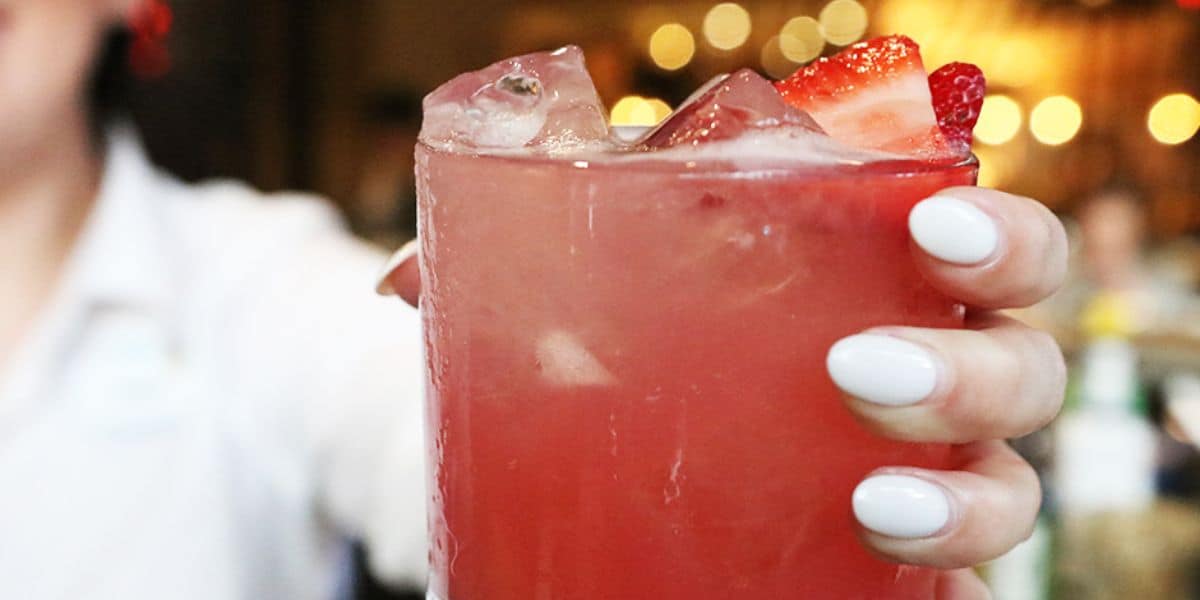 A woman's hand holding a cocktail