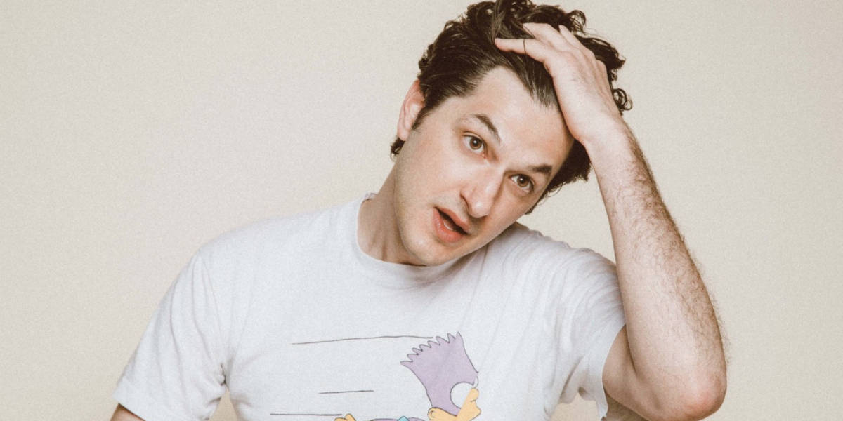 Ben Schwartz running his fingers through his hair