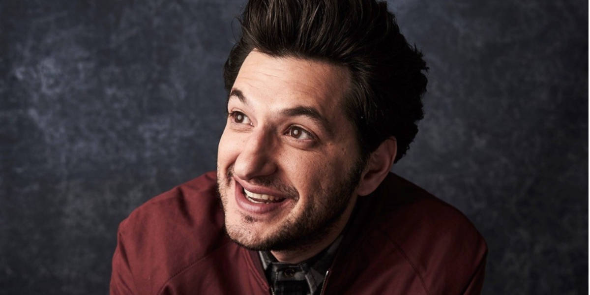 Ben Schwartz smiling and looking off-camera
