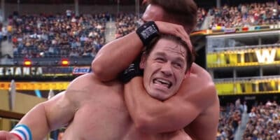 Austin Theory holding John Cena in a sleeper hold