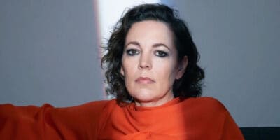 Olivia Colman in red with a band of light across her face