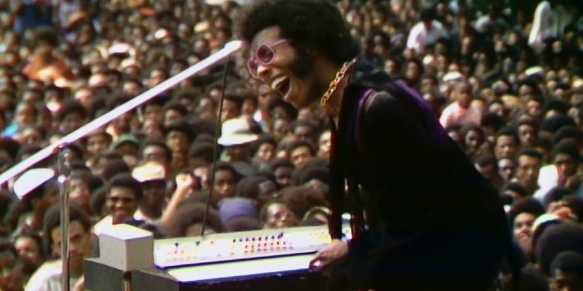 Man playing keyboard in front of a crowd disney