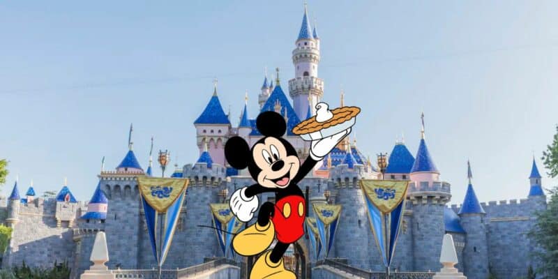 Mickey holding a pie in front of Sleeping Beauty Castle