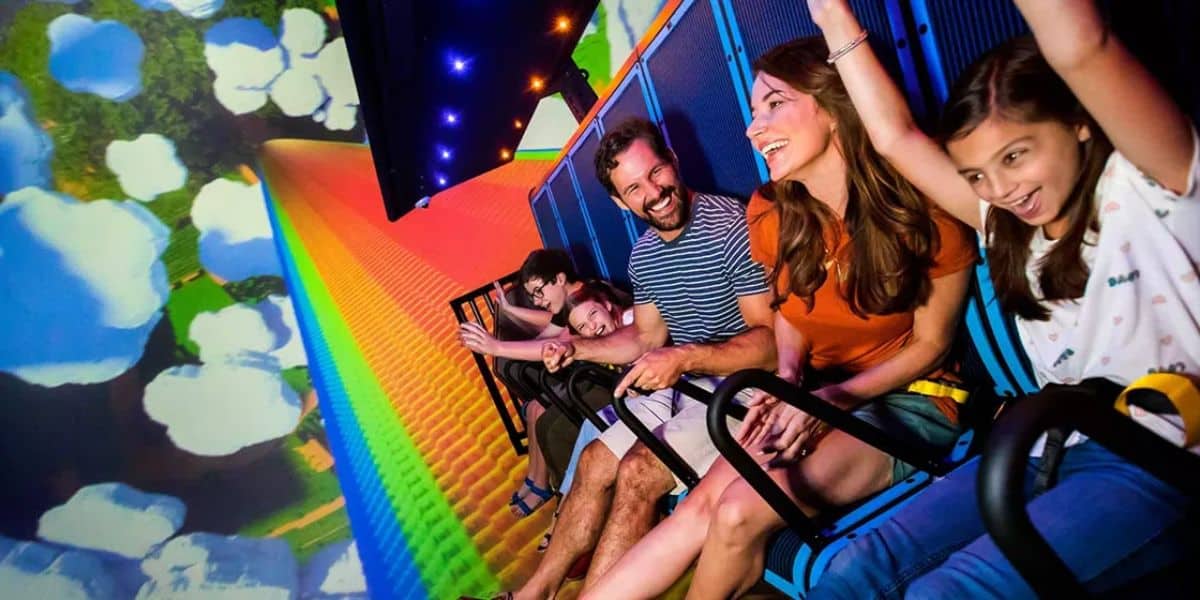 Family smiles and laughs riding ride at LEGOLAND