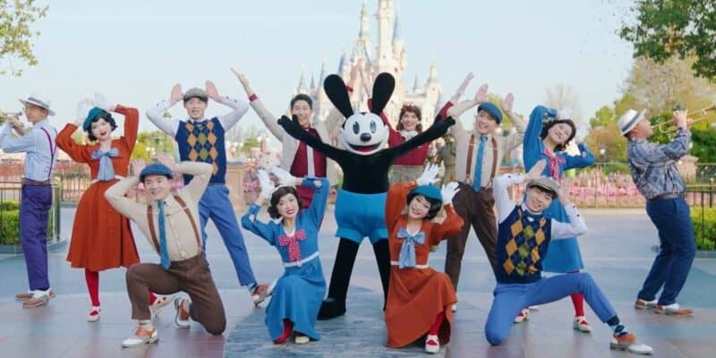 Oswald poses in front of the castle with other performers