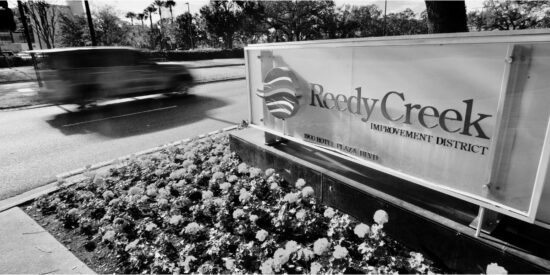 a grey photo of the front sign of Reedy Creek inside Walt Disney World.