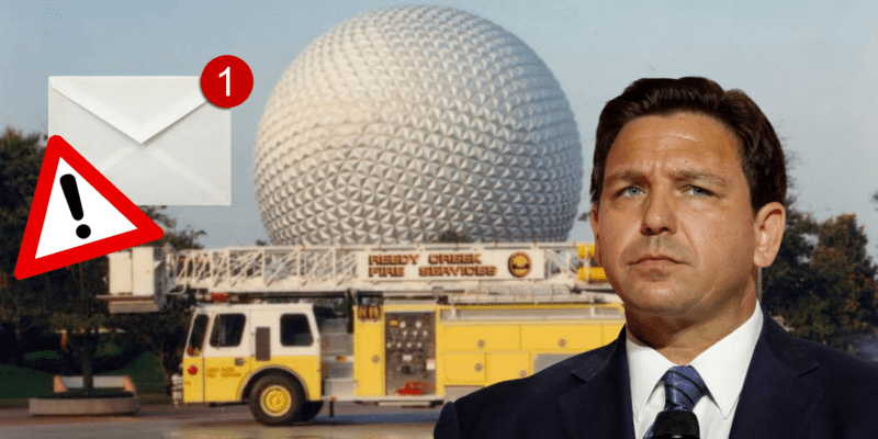 An email envelope with a notification reading "1" and an exclamation point in a bright red triangle, an image of Ron DeSantis looking pensive. Both of these images are on top of a photo of a yellow Reedy Creek firetruck in front of Spaceship Earth at EPCOT.