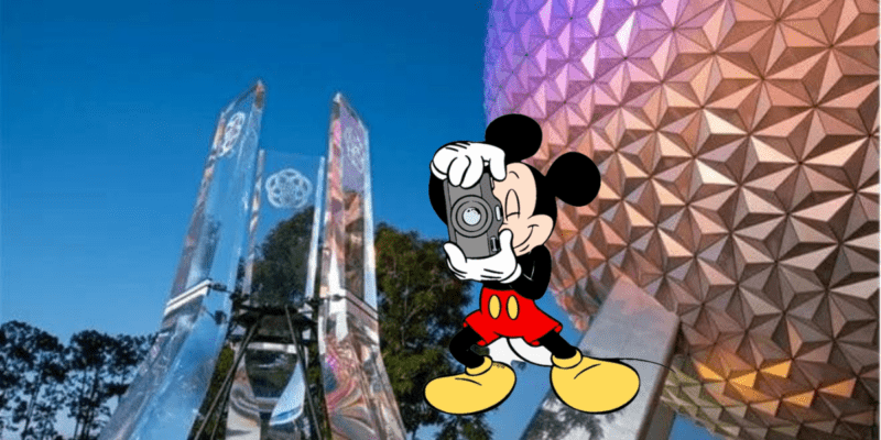 Mickey Mouse with a camera (representing a Disney vlogger) stands in front of Spaceship Earth at EPCOT around dusk.