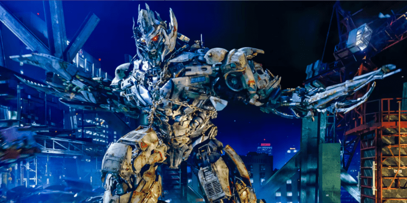 A large metal Transformer tears through a city.