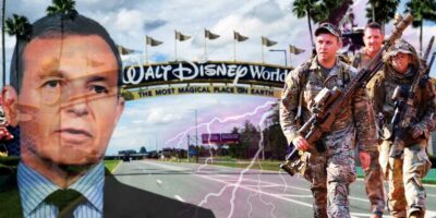 Bob Iger and National Guard troops in front of Walt Disney World sign