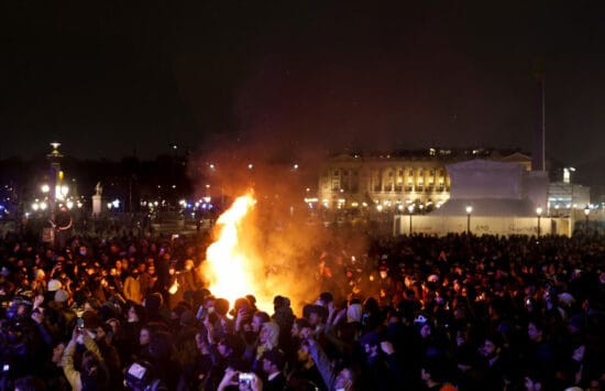 Fire emerges as people attend a demonstration on Place de la Concorde to protest the use by French government of the article 49.3, a special clause in the French Constitution, to push the pensions reform bill through the National Assembly without a vote by lawmakers, in Paris, France, March 17, 2023. REUTERS/Gonzalo Fuentes