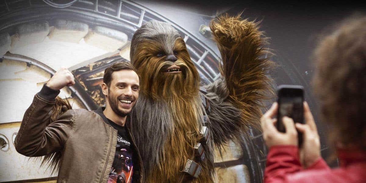 A fan takes a picture with Chewbacca