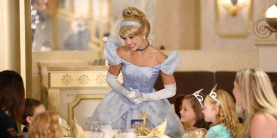 Cinderella meets young Guests at Cinderella's Royal Table, a Walt Disney World restaurant.