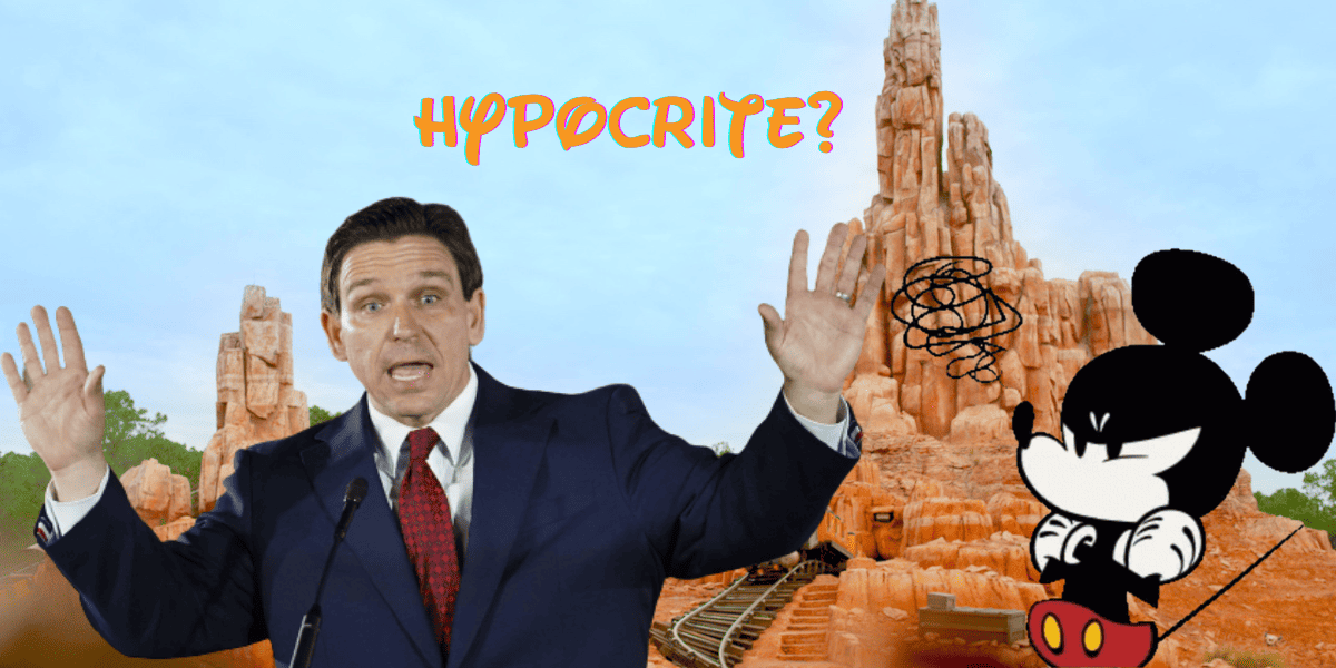 Ron DeSantis speaking frantically, Mickey Mouse looks angry, text reading "hypocrite?" all in front of big thunder mountain at Walt Disney World Resort.