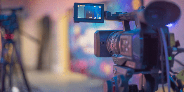 A camera films with a burry background. No people are in the photo, referencing the emptiness of the Hollywood strike.