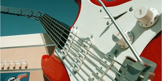 An oversized electric guitar in front of the entrance to a Disney world rollercoaster