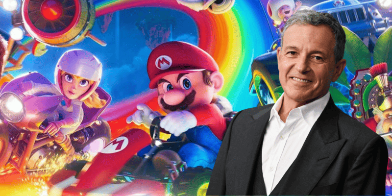 Disney CEO Bob Iger edited in front of a poster for The Super Mario Bros. Movie, featuring Mario and Peach on Mario Karts.