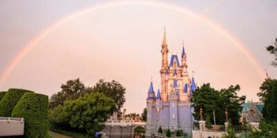 Cinderella Castle at Disney World with a rainbow arcing through the sky