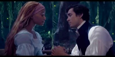 Ariel and Eric "Kiss the Girl" scene, leaning in on boat, from The Little Mermaid 2023 remake