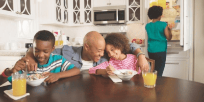 Family enjoying breakfast at a kitchen in their Disney Villa