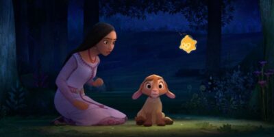 Asha (Ariana DeBose) kneels down next to her goat in 'Wish'