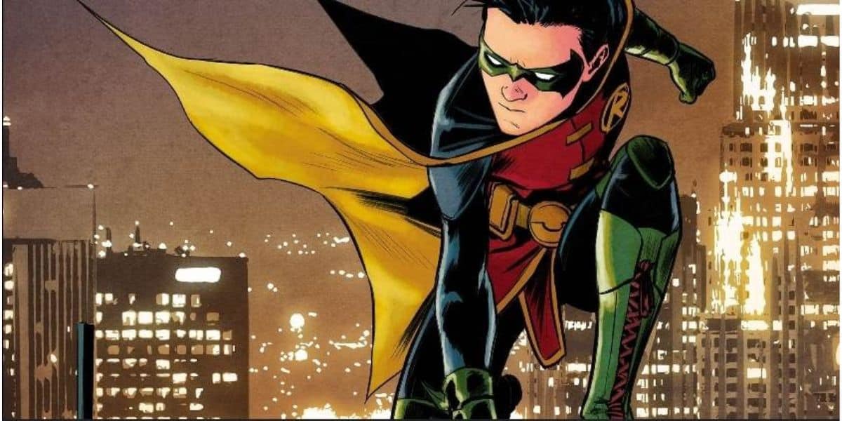 Damian Wayne as Robin crouching on top of building with Gotham City in the background