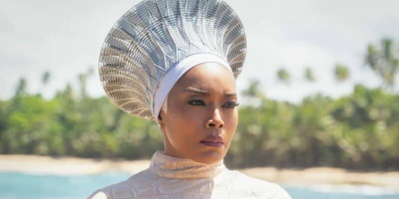 Queen Ramonda (Angela Bassett) in all white on a beach