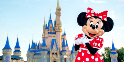 Minnie Mouse posing in front of Cinderella Castle