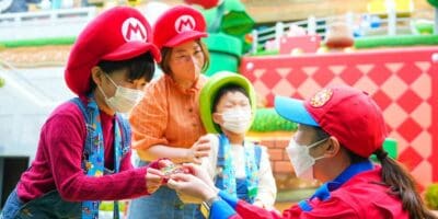 Guests dressed as Super Mario characters with a Team Member at Universal Studios Japan