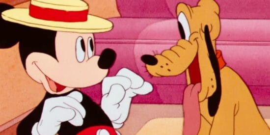 Pluto stares at Mickey wearing a hat in an animated short