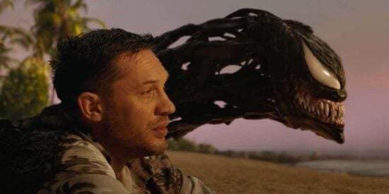 Venom and Eddie (Tom Hardy) on a beach in 'Venom: Let There Be Carnage'