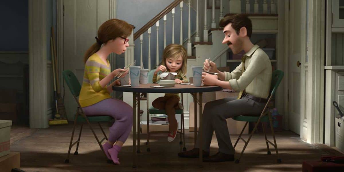 Riley sits at the dinner table with her mom and dad