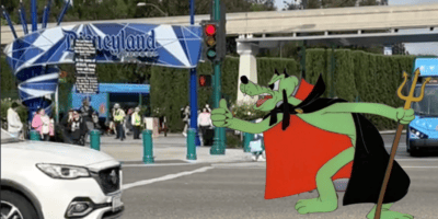 Christians at a Disneyland protest outside the gates, Pluto in a Devil costume