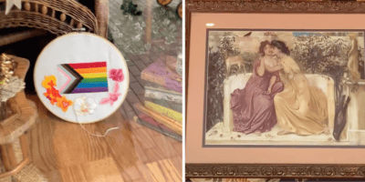 A pride flag cross stitch, historic art of two women kissing. (Part of a Disneyland Pride display)