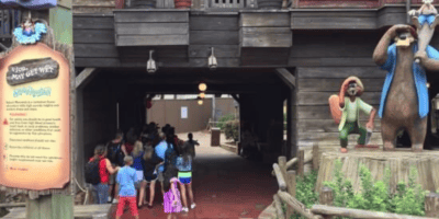 Guests resting in a shady area under a bridge near the former location of Splash Mountain, a now-closed Disney World ride, in Frontierland at Magic Kingdom Park.