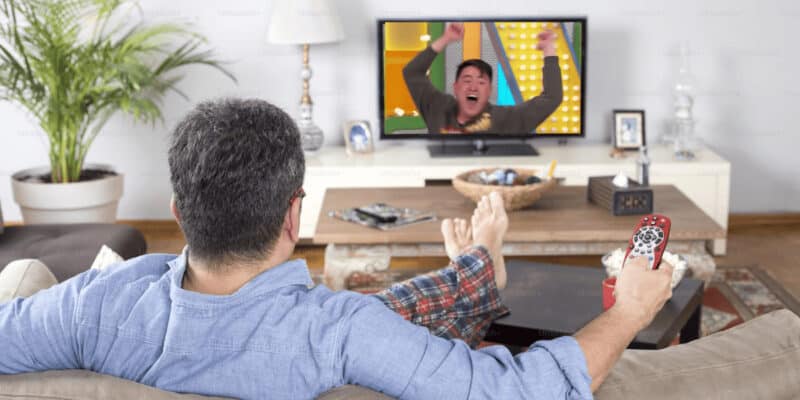 A person watching a man jump around on The Price is Right.