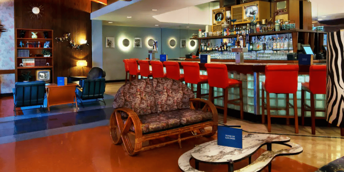 A lounge set up to look like a living room, where Disney World Restaurant Guests wait to be taken to their tables.