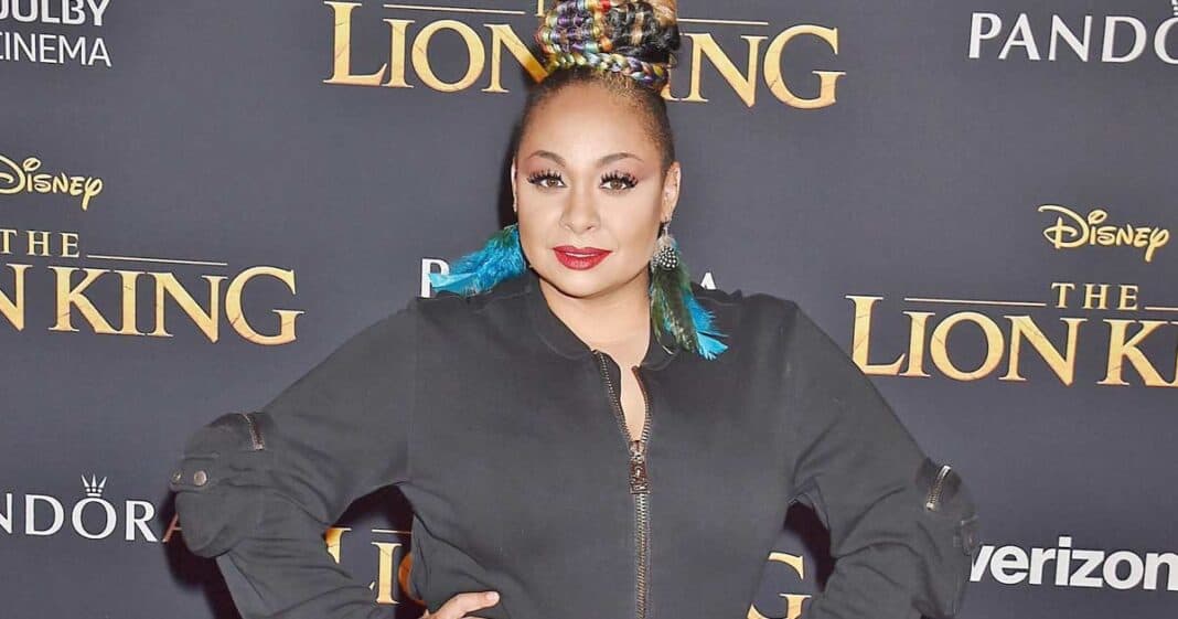 Raven-Symone controversy regarding her personal life as she stands in front of Disney 'Lion King' poster | Credit: Disney