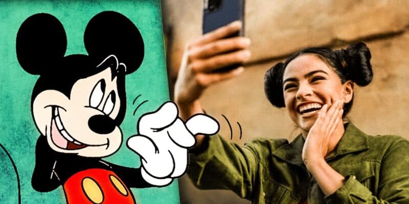 Influencer taking pictures at Disney Park (Selfie at Star Wars: Galaxy's Edge) with Mickey Mouse waving nervously
