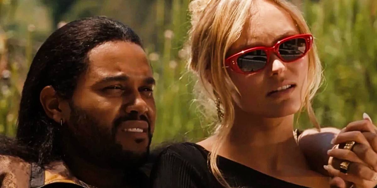 A still from The Idol featuring Abel Tesfaye and Lily-Rose Depp sitting together