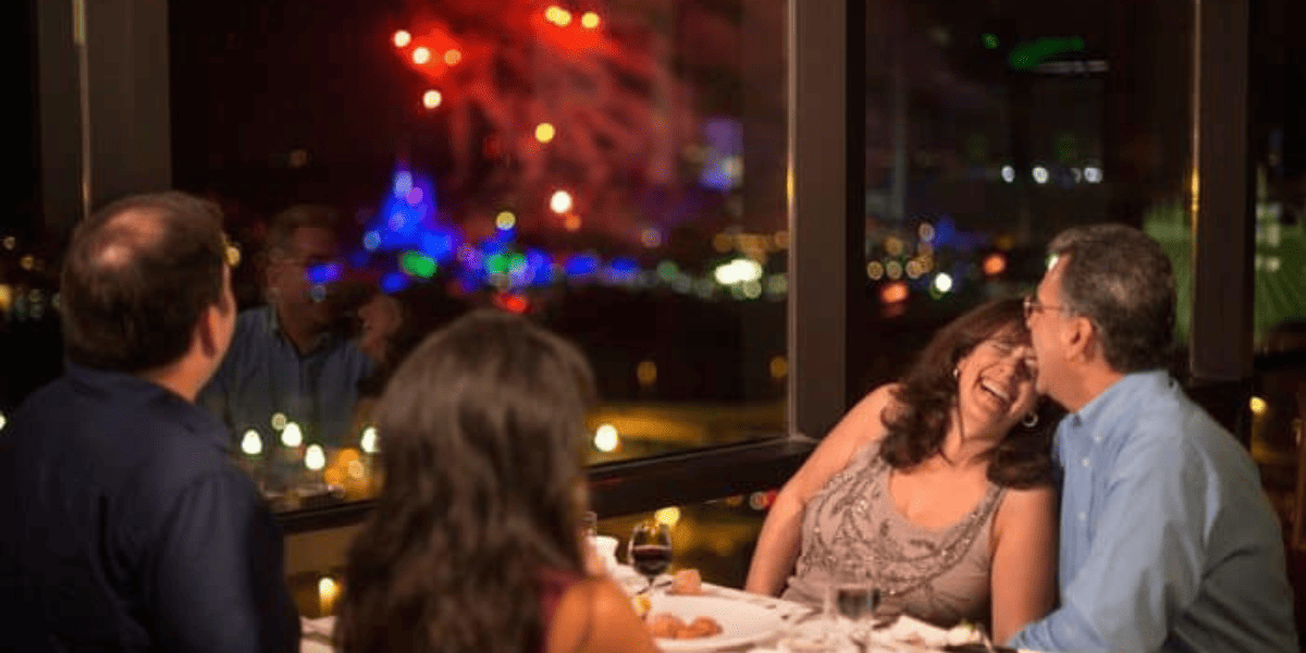 Two adult couples dining at California Grill during fireworks