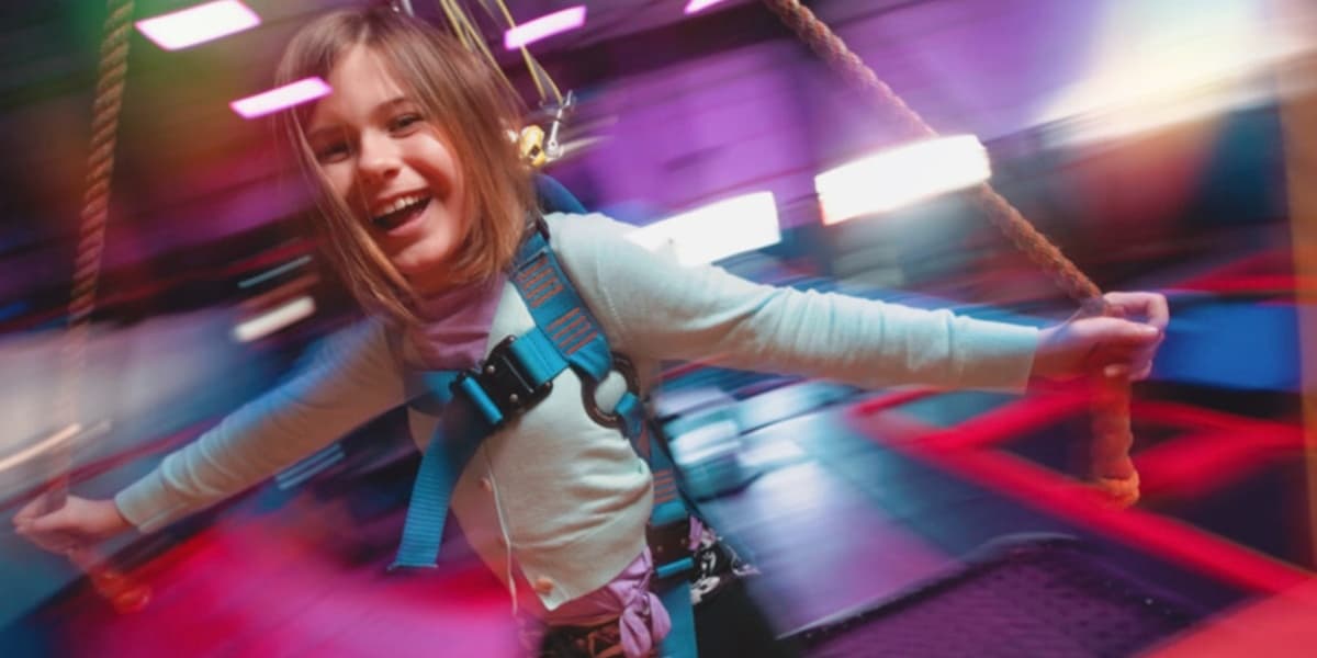 A girl riding the Sky Rider at Urban Air