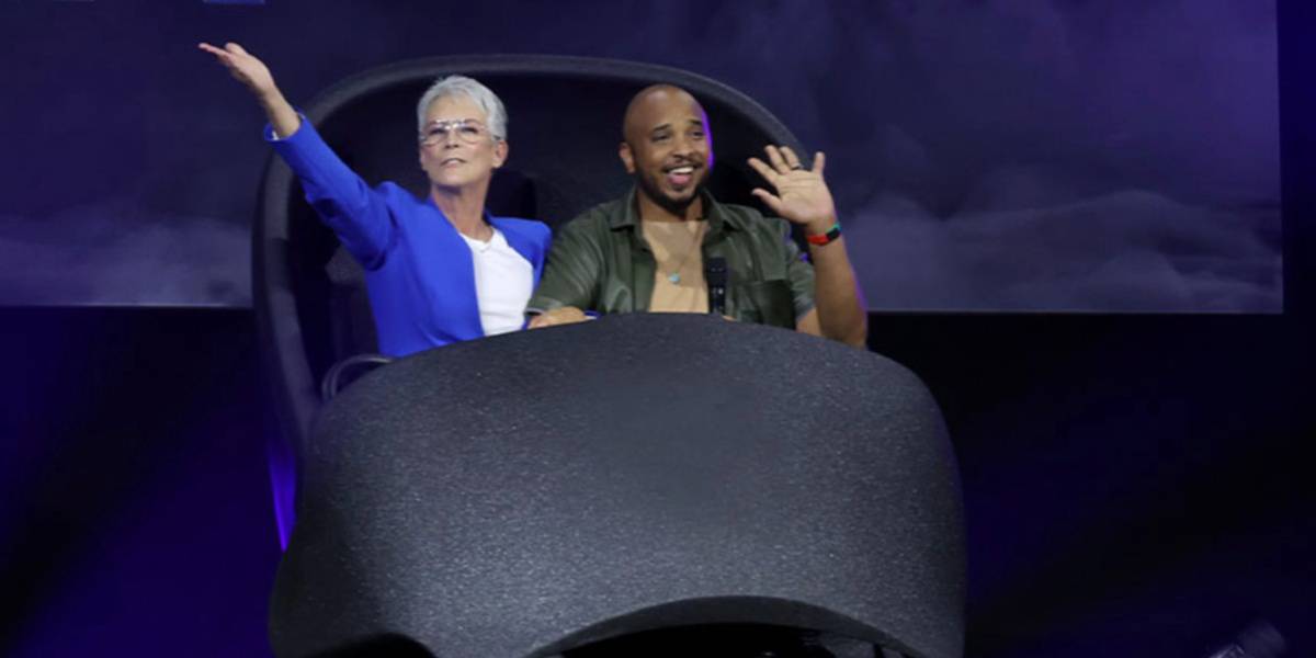 Justin Simien and Jamie Lee Curtis riding in a Doom Buggy from Haunted Mansion