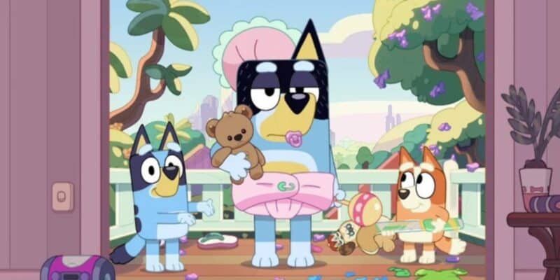 Bandit dressed as a baby with Bluey and Bingo